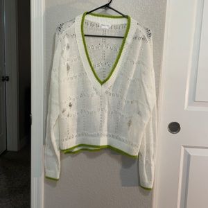 Cream knitted v-neck distressed sweater with green trim. Women’s size Small